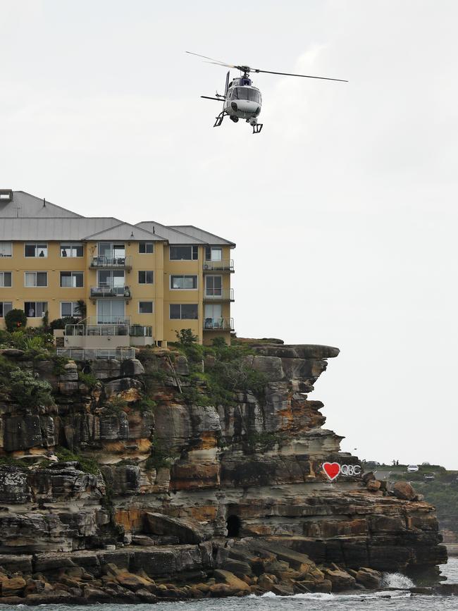 Polair police helicopter patrols over Manly Beach to ensure people aren't gathering together. Picture: Sam Ruttyn