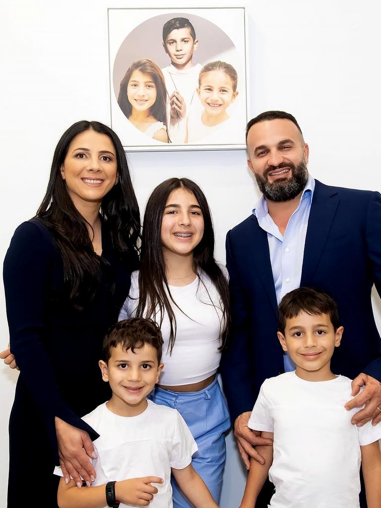 Leila and Danny Abdallah with their children Liana, 12, Alex, 7, and Michael, 5. They are with a portrait of Antony, Angelina and Sienna.