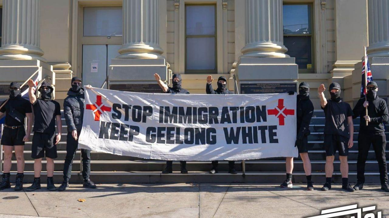 A group from the Nationalist Socialist Movement poses for a photo in front of Geelong City Hall.