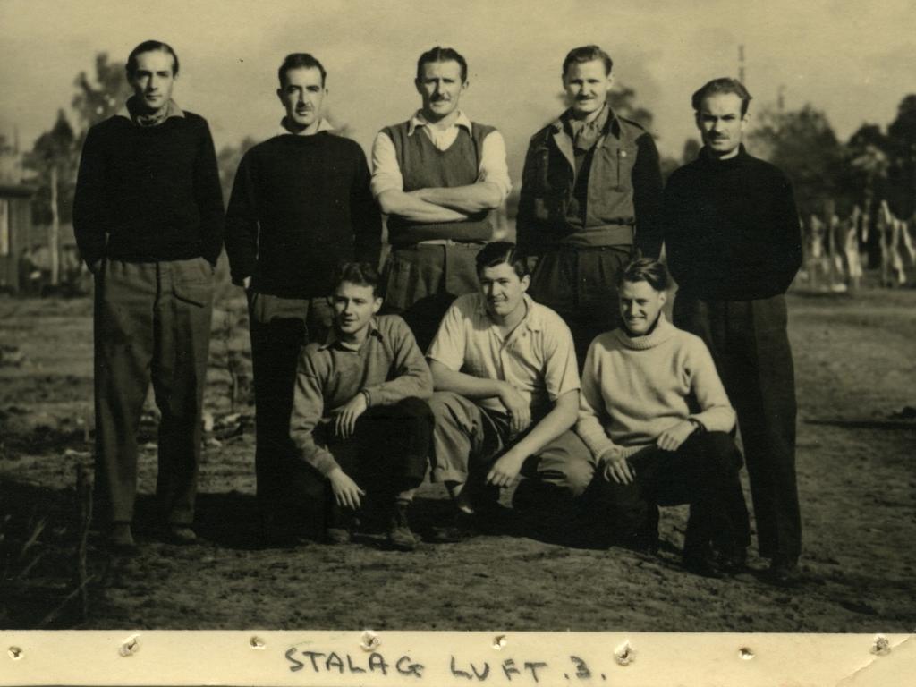 Australian Squadron Leader James Catanach (kneeling, right) with fellow prisoners of war at Stalag Luft III. Picture: The Shrine of Remembrance