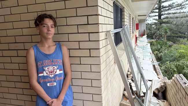 King Tide apartments resident Lincoln, 14, surveys the after-effects of Cyclone Alfred closing in on Friday night.