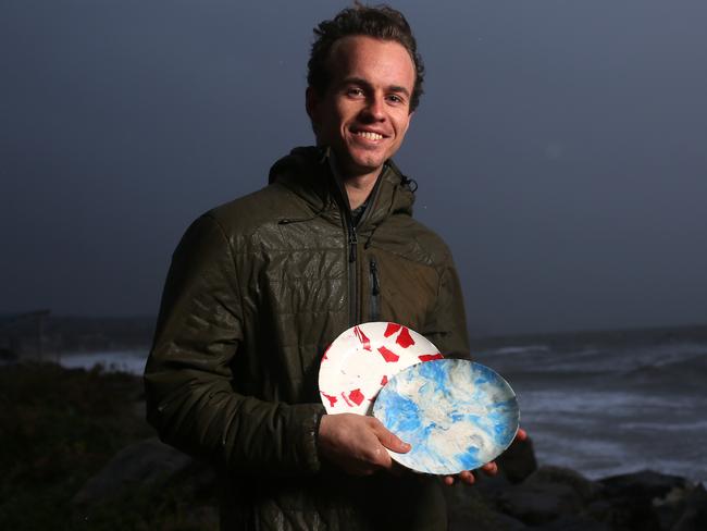 Aiden Ryan with plates remade from recovered plastic. AAP image/Emma Brasier