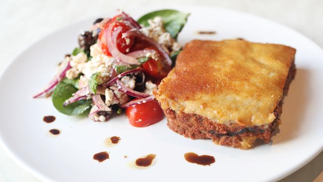 The moussaka, baked layers of mince, potato and eggplant topped with bechamel sauce and served with Greek salad. Picture: NIKKI DAVIS-JONES