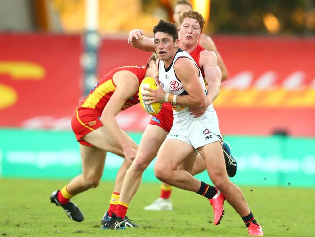 Adelaide’s Chayce Jones of the Crows is tackled by Matthew Rowell of the Suns during the round 3 AFL match at Metricon Stadium. Picture: CHRIS HYDE/GETTY IMAGES