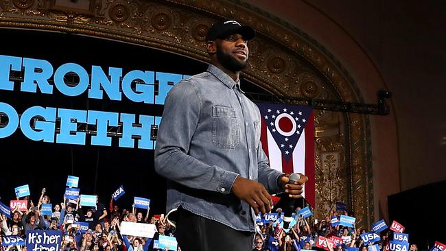 LeBron James walks on stage during a campaign rally with Democratic presidential nominee.