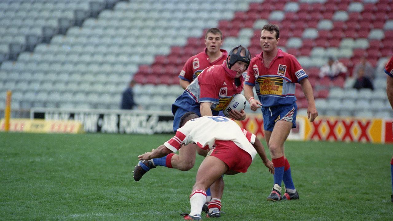 Clydesdales backrower Tony Evans attempts to bump off the tackle of Redcliffe five-eighth Thomas O'Reilly.