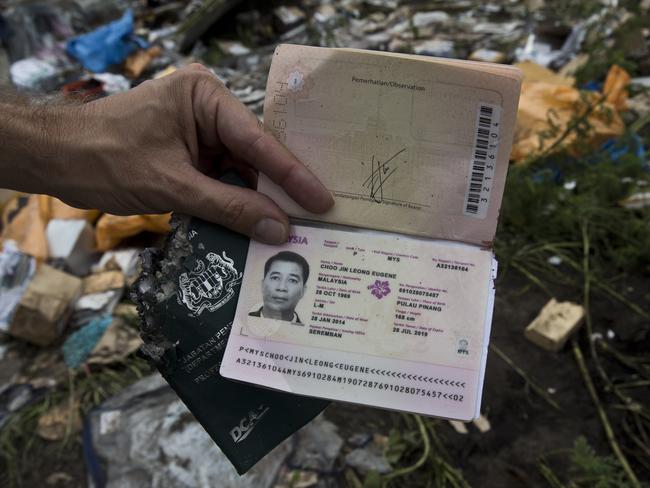 The passport ... of Captain Choo Jin Leong Eugene found by a News Corp team among the debris found scattered on the ground where Malaysian Airlines flight MH17 crashed. Picture: Ella Pellegrini