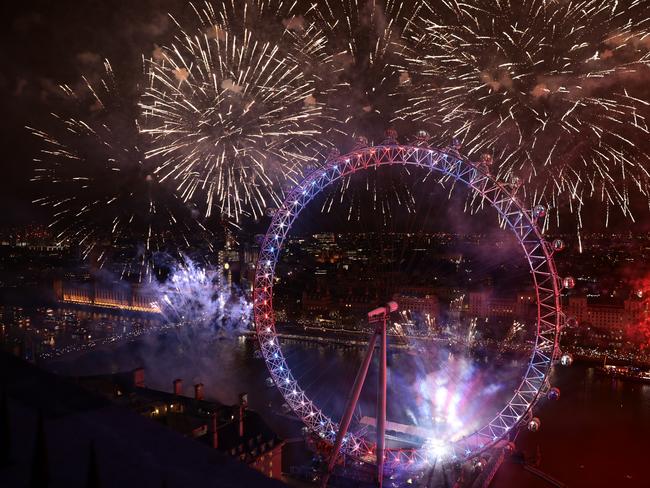 Fireworks explode over The London Eye and Elizabeth Tower near Parliament as thousands of revelers gather along the banks of the River Thames. Picture: Getty