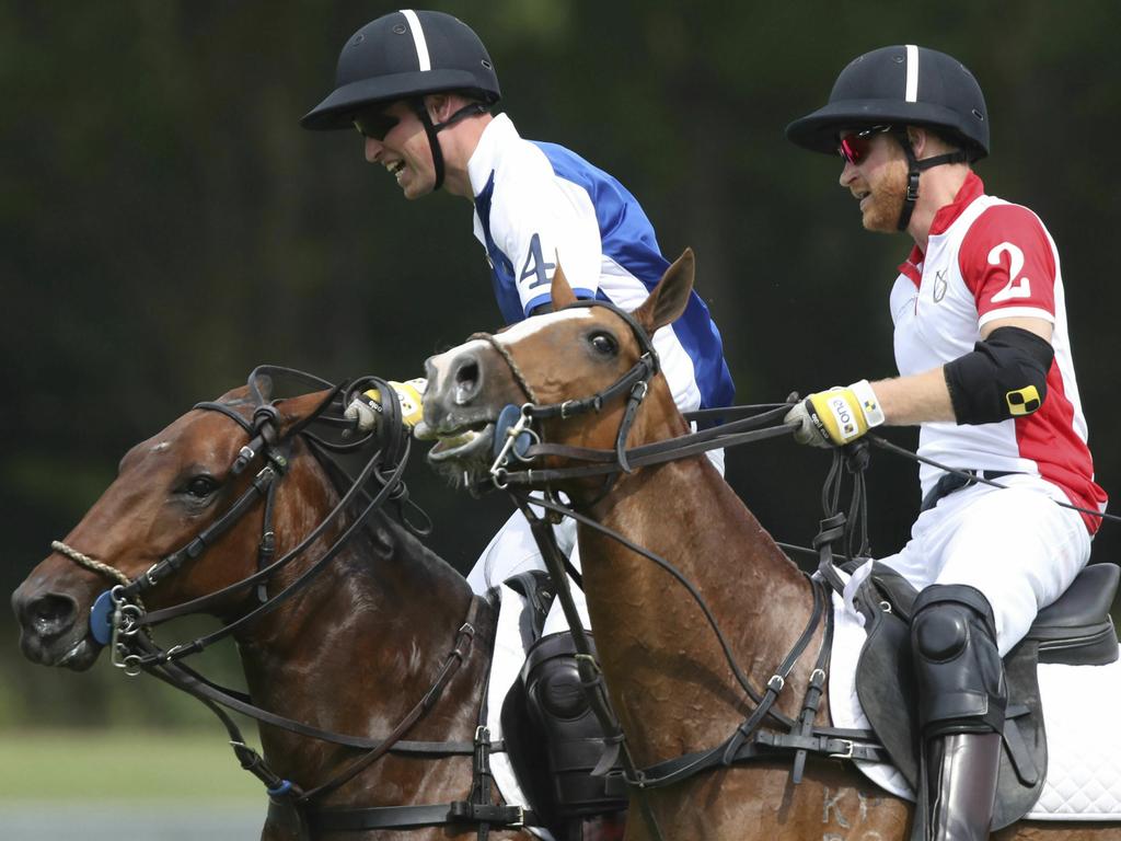 William, left, and Harry, right, compete against each other. Picture: Andrew Matthews/PA via AP