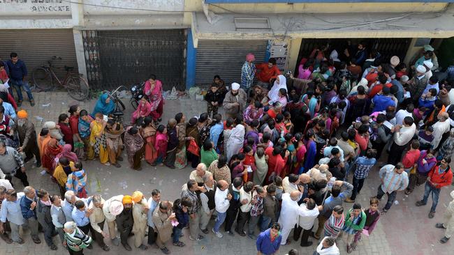 Indian people queue outside a bank as they wait to deposit and exchange 500 and 1000 rupee notes in Amritsar on November 13. Picture: Narinder Nanu/AFP