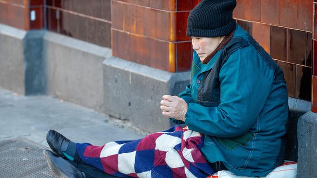 A beggar, older and asian in appearance, on the corner of Flinders and Swanston St, Melbourne. Picture: Mark Stewart