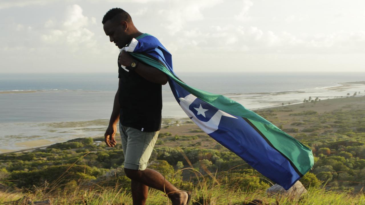 Cairns resident Bernard Namok, whose father designed the Torres Strait Islander Flag, poses for a photo at St. Pauls in Moa Island, during his film 'Carry The Flag'. Picture: NT Travelling Film Festival