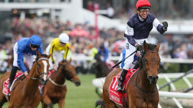 Almandin (right), ridden by jockey Kerrin McEvoy, wins the 2016 Melbourne Cup on Melbourne Cup Day at Flemington Racecourse in Melbourne, Tuesday. Nov. 1, 2016. (AAP Image David/Crosling) NO ARCHIVING, EDITORIAL USE ONLY