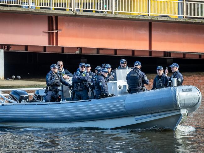 Police monitor the Yarra River. Picture: Jake Nowakowski