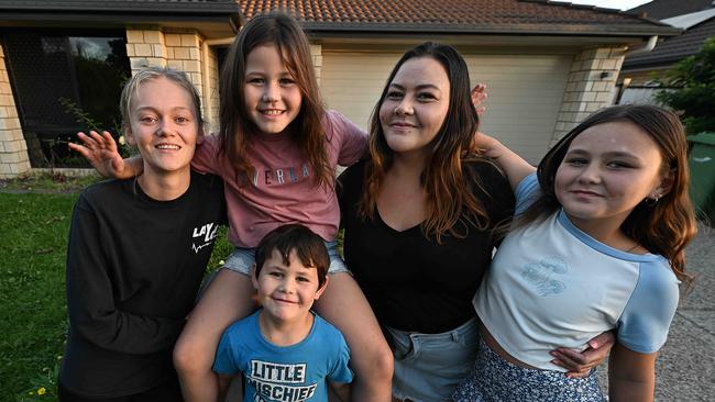 Excited and happy L-R Venenetia Treweek 20, Jah Bennett-James 9, Leigion Bennett 7, Joval Bennett and Navaeh Bennett 11, outside their new home in Caboolture. Pic: Lyndon Mechielsen