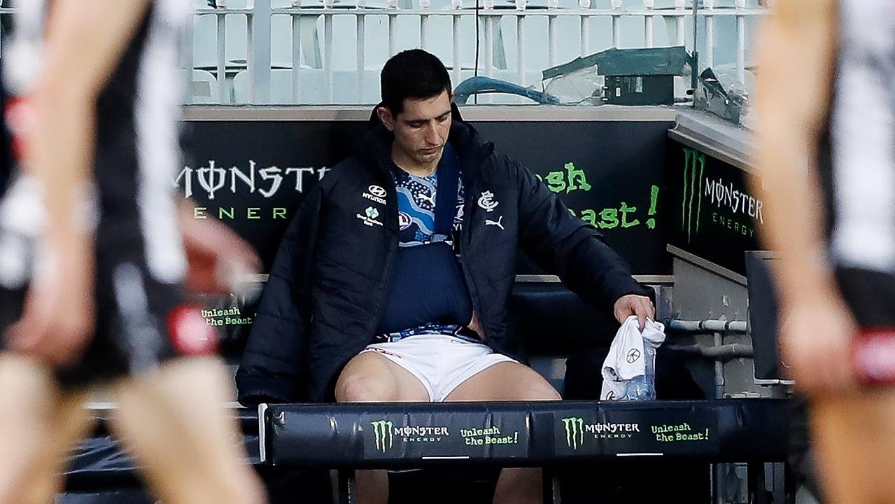 A dejected Jacob Weitering sits on the bench after being injured against Collingwood. Picture: Dylan Burns/AFL Photos via Getty Images