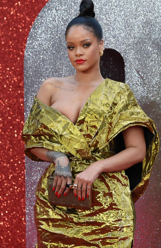 Rihanna looked in danger of losing one half of her dress. Picture: AFP