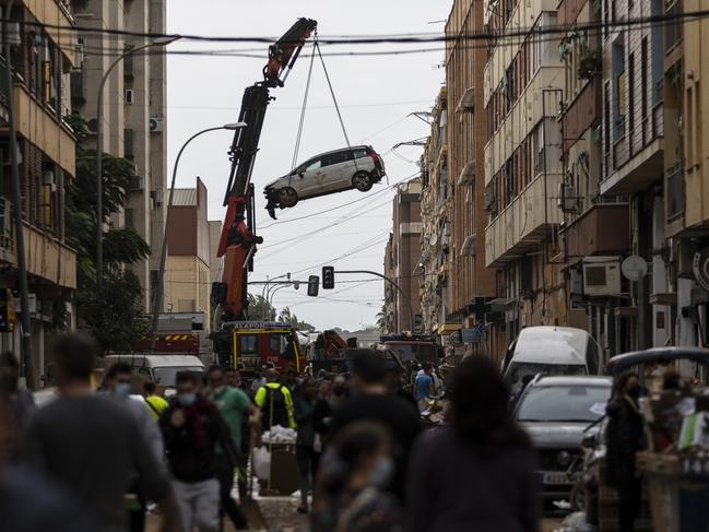 A crane removes a car after heavy rain and flooding in Valencia, Spain. Picture: Getty Images