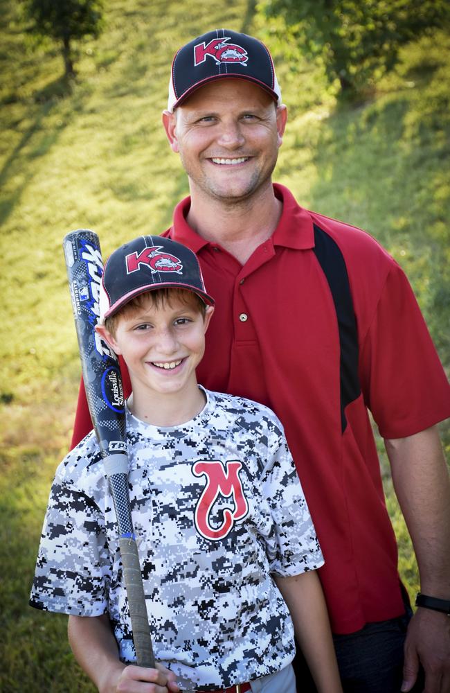 Caleb Thomas Schwab, 10, with his father Scott Schwab in June. Picture: David Strickland/David Strickland via AP