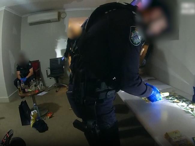 Police counting cash after an alleged drug bust in Mount Isa, Queensland as part of Operation Whiskey Decker, which included the Mount Isa Tactical Crime Squad Northern Major and Organised Crime Squad (MOCS) and Gold Coast MOCS in May 2025. 19 people have been charged with 271 drug offences.