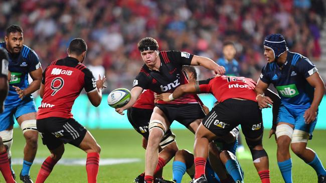 Scott Barrett of the Crusaders passes the ball at AMI Stadium.