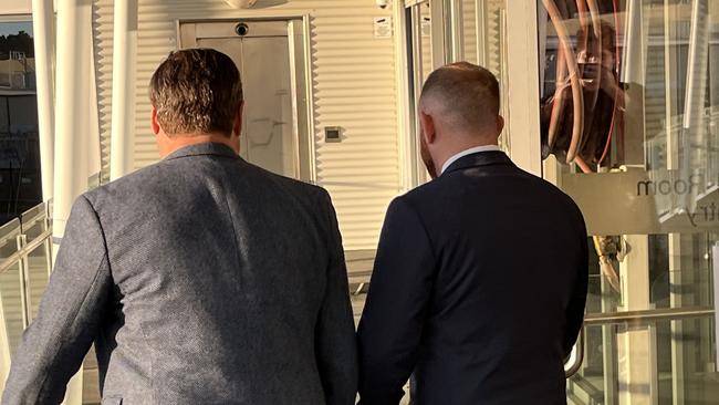 Michael Burke (right) leaves the Defence Force Magistrates Court with a supporter on August 31 2022. Picture: Julia Kanapathippillai