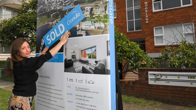 Real estate agent Adrianna May with a newly sold property in Cronulla, southern Sydney on March 28. Picture: AAP