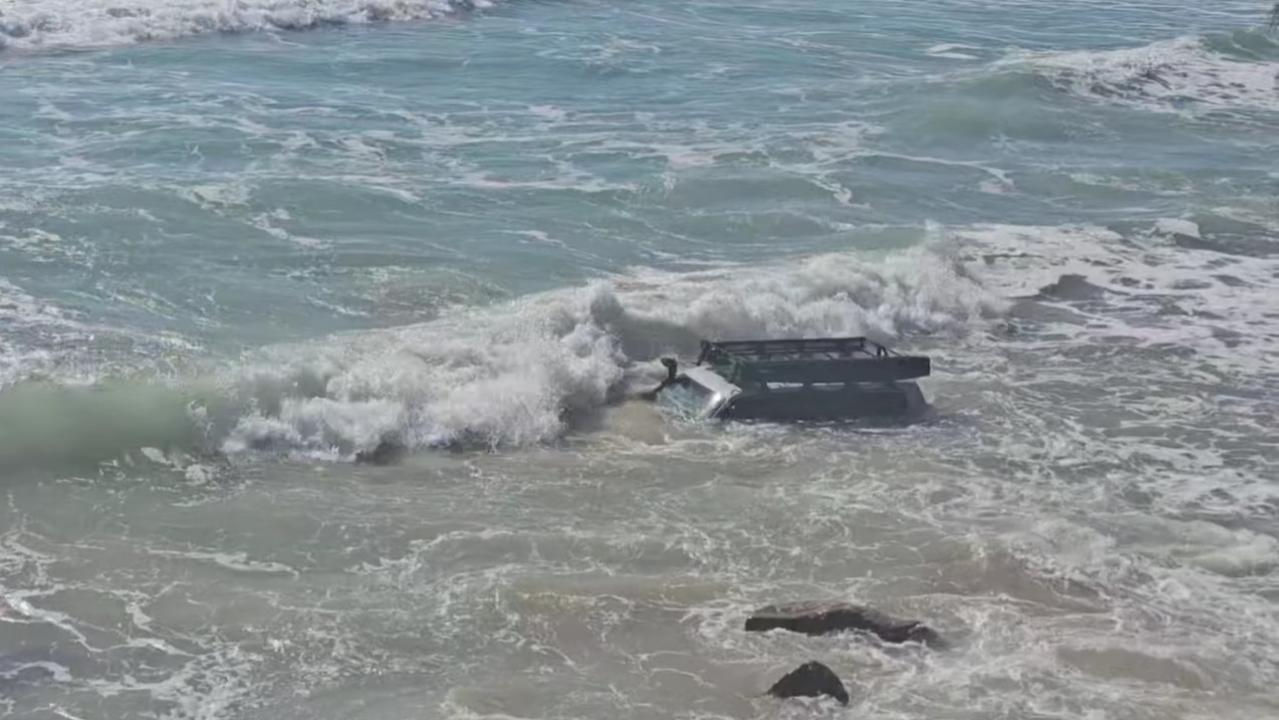 Footage and pictures on Facebook showed two four-wheel drives being pounded by waves and inundated with water. Picture: Facebook/ I Got Bogged at Inskip Point