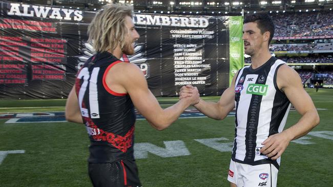 AFL Round 6. 24/04/2019. Richmond v Melbourne at the MCG.  Skippers Dyson Heppell  and Scott Pendlebury  meet infant of the banner pre game    . Pic: Michael Klein.