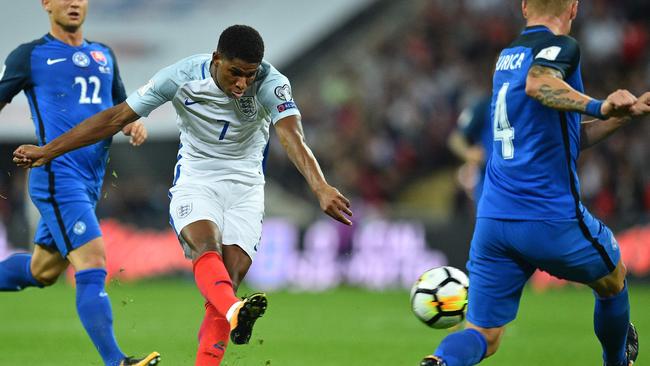 England's striker Marcus Rashford shoots to score England's second goal.