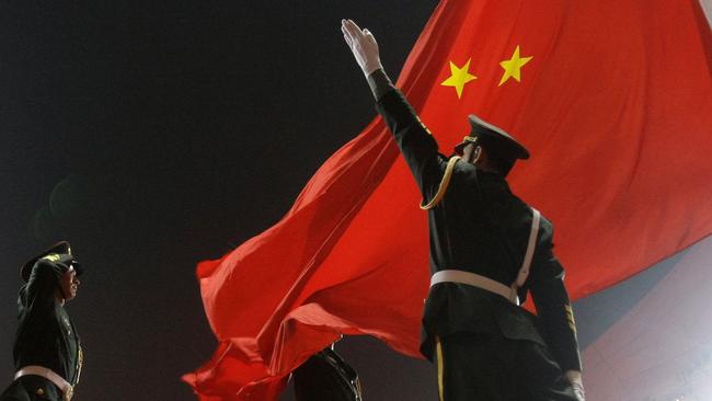 Chinese military soldiers salute as the Chinese flag is raised during the Opening Ceremony of the 2008 Beijing Olympic Games in Beijing, China 08/08/2008.