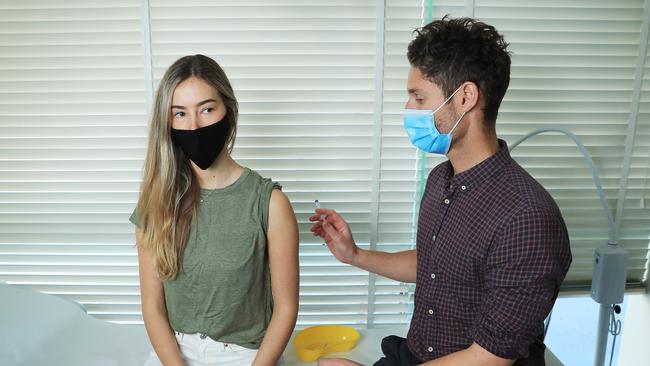 Gabi Blomson receives the AstraZeneca jab from Dr Stephen Massey at Bondi Doctors, following the announcement under-40s are able to get the shot from a GP immediately. Picture: John Feder