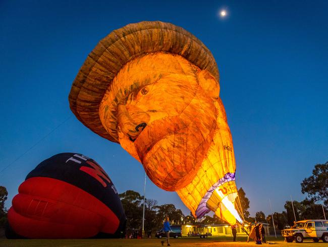 Flames light up the dark sky in preparation for lift-off. Picture: Jake Nowakowski