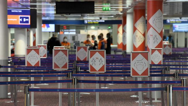 Placards with pictograms depicting Covid-19 sanitary instructions in a queuing area of the Terminal 2E’s arrival level of the Roissy-Charles de Gaulle airport near Paris. officials hope a Covid-19 vaccine certificate will help spur travel across the EU. Picture: AFP