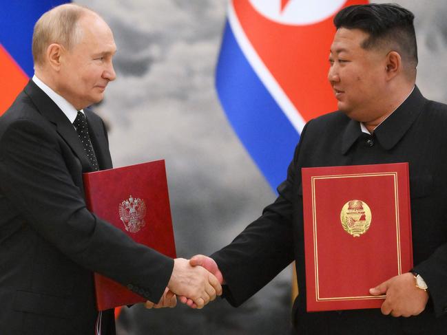 Vladimir Putin and Kim Jong-un seal a signing ceremony following their bilateral talks in Pyongyang with a handshake. Picture: AFP