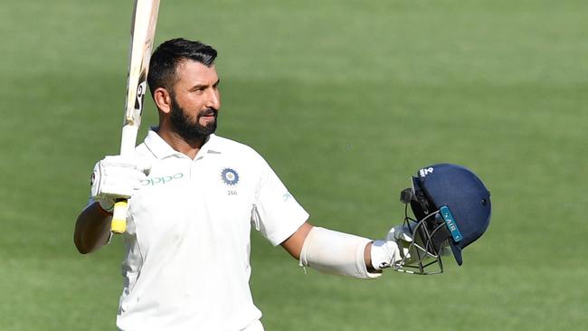 Indian batsman Cheteshwar Pujara celebrates bringing up his century at Adelaide Oval on Thursday. Picture: AAP