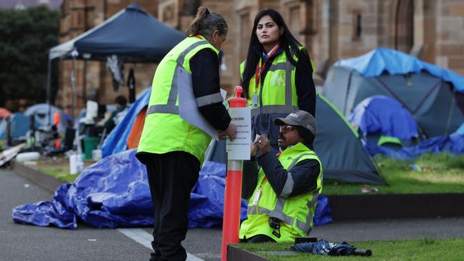 University of Sydney security personnel put up signs on Monday warning failure to follow directions to leave would be an offence. Picture: Jane Dempster