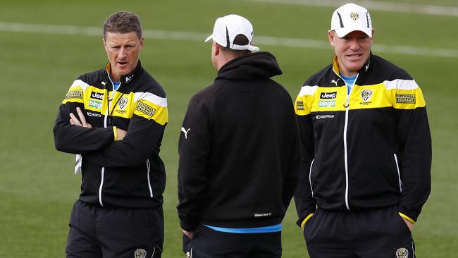 Richmond coach Damien Hardwick chats with two assistant coaches, including Justin Leppitsch, at training.