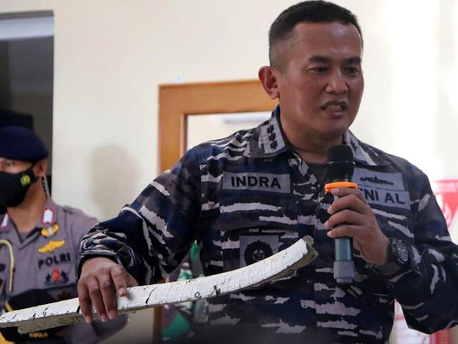 An Indonesian naval officer shows parts of the torpedo system found in the search operation for the KRI Nanggala 402. Picture: AFP