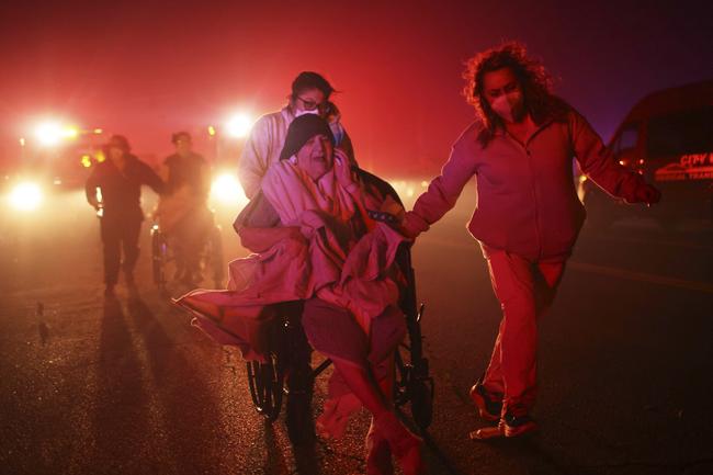 Residents of a seniors’ centre are evacuated in Altadena. Picture: AP