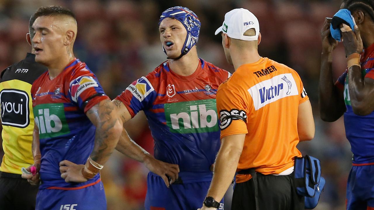 Kalyn Ponga of the Newcastle Knights talks to the trainer during their loss to the Dragons on Sunday.