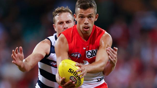 Sydney’s Oliver Florent looks a to get a handball away against Geelong in Round 2.