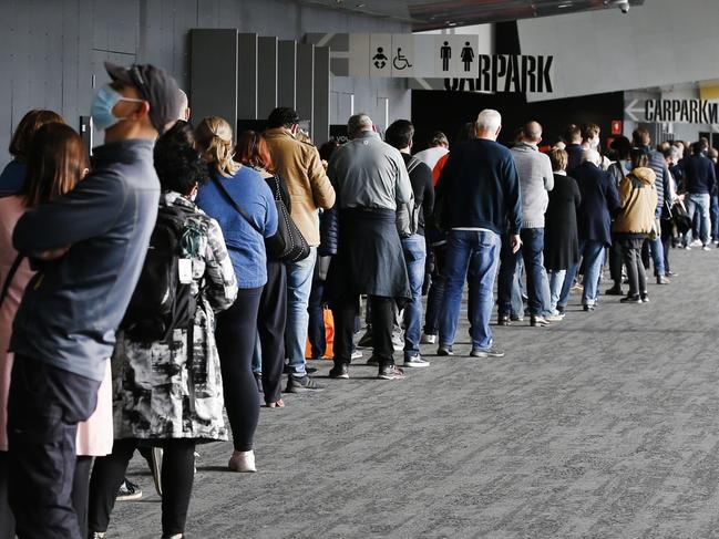 Crowds flock to vaccine hubs to get the jab after the COVID lockdown was announced at the Melbourne Exhibition Centre.                      Picture: David Caird