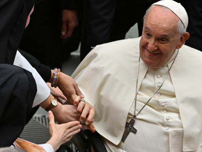 Pope Francis greets people at the end of an audience  the weekly general audience to the participants of the International Meeting for Shrine Rectors and Shrine Workerson on November 11, 2023 at Paul-VI hall in The Vatican. (Photo by Andreas SOLARO / AFP)