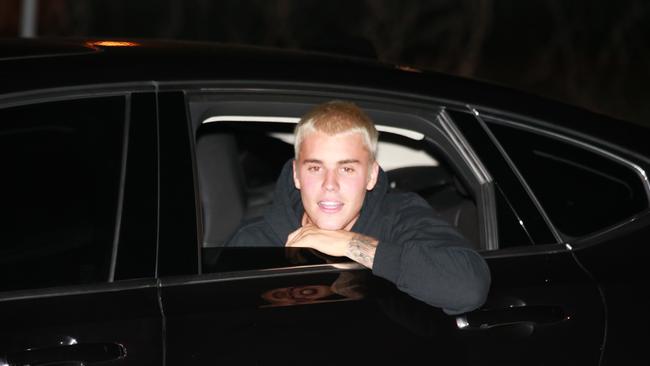 Justin Bieber showed signs of learning his lesson when he arrived in Brisbane, and greeted fans from his car window. (Pic: Adam Armstrong)