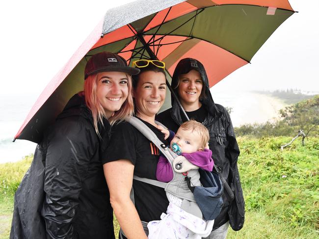 WEATHER: Out and about in the rain at Point Cartwright are Kendra Froese, Leilan and Zoe Power, 8 months with Jill Dallin. Photo Patrick Woods / Sunshine Coast Daily.