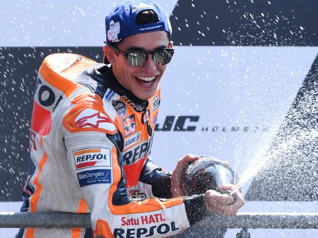 TOPSHOT - Winner Repsol Honda Team's Spanish rider Marc Marquez celebrates on the podium after the MotoGP race of the French motorcycling Grand Prix on May 20, 2018, in Le Mans, northwestern France.  / AFP PHOTO / Jean-Francois MONIER