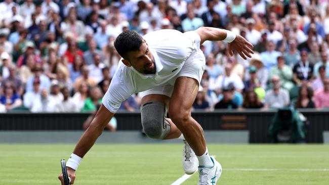 Novak Djokovic of Serbia falls as he plays a forehand against Jacob Fearnley of Great Britain. Picture: Francois Nel/Getty Images