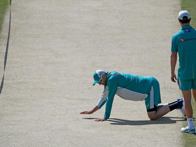 Australia's Nathan Lyon (L) inspects the pitch before a practice session at the Rawalpindi Cricket Stadium in Rawalpindi on March 1, 2022, ahead of the first cricket Test match between Pakistan and Australia. (Photo by Aamir QURESHI / AFP)