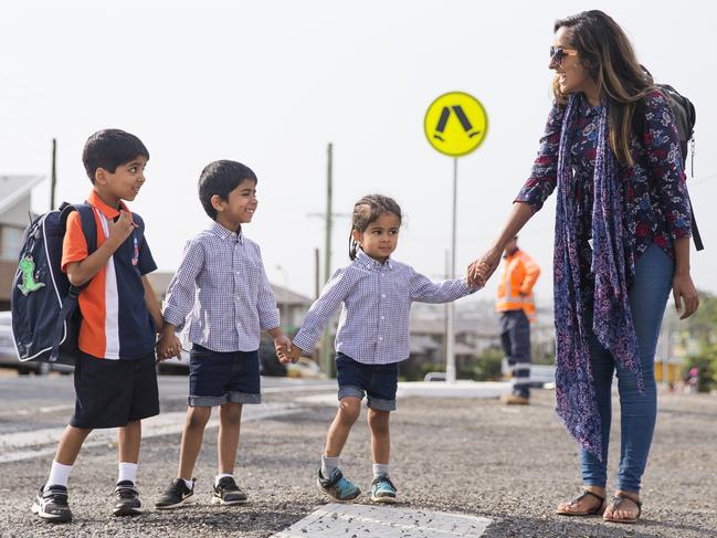 Jibraeel Ahmad, 6, walking to school with siblings Ismaeel Ahmad, 4, Azaeel Ahmad, 3, and mum Sharna Khan. Students. Picture: Dylan Robinson